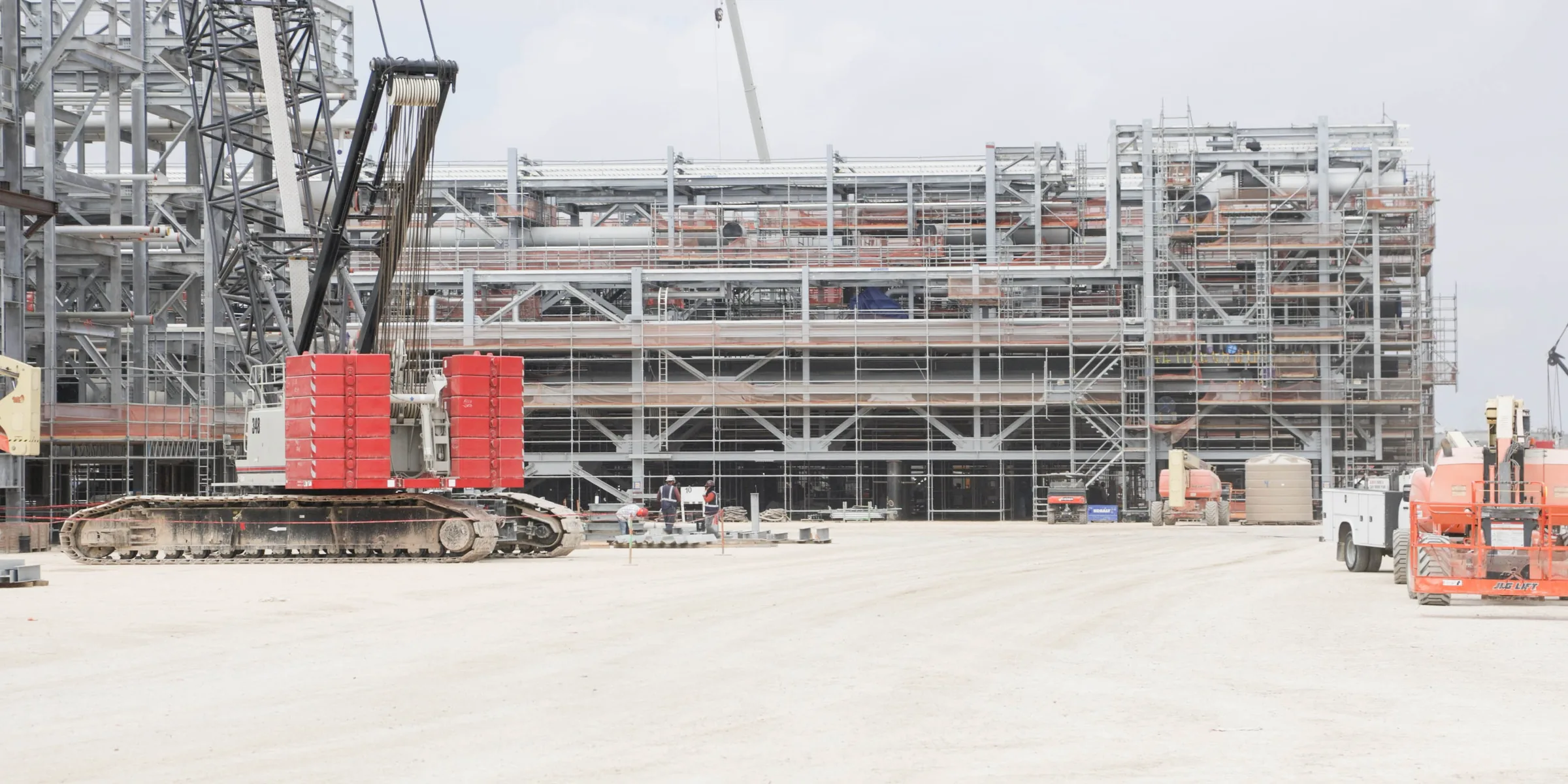 Crawler crane and structural steel under erection at the State Service yard in Ingleside, Texas